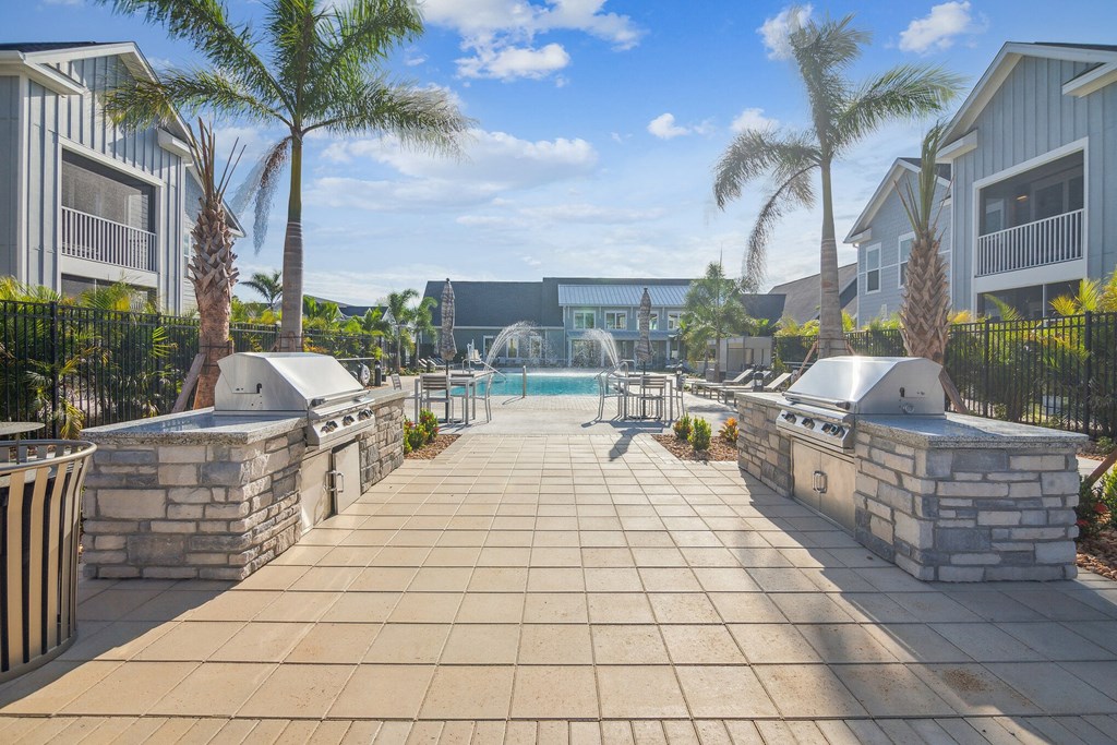 a resort style pool with two hot tubs and palm trees  at Palm Grove, Ellenton, 34222