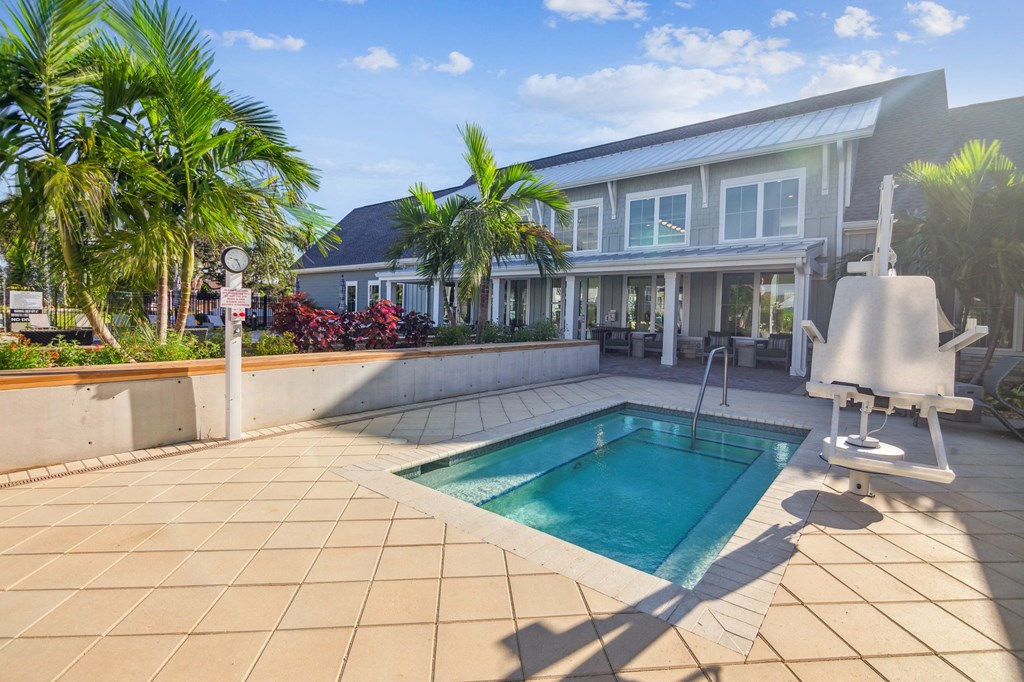 a swimming pool in front of a house  at Palm Grove, Ellenton, FL