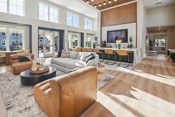 a living room with a couch and a table in front of a tv  at Palm Grove, Ellenton, Florida