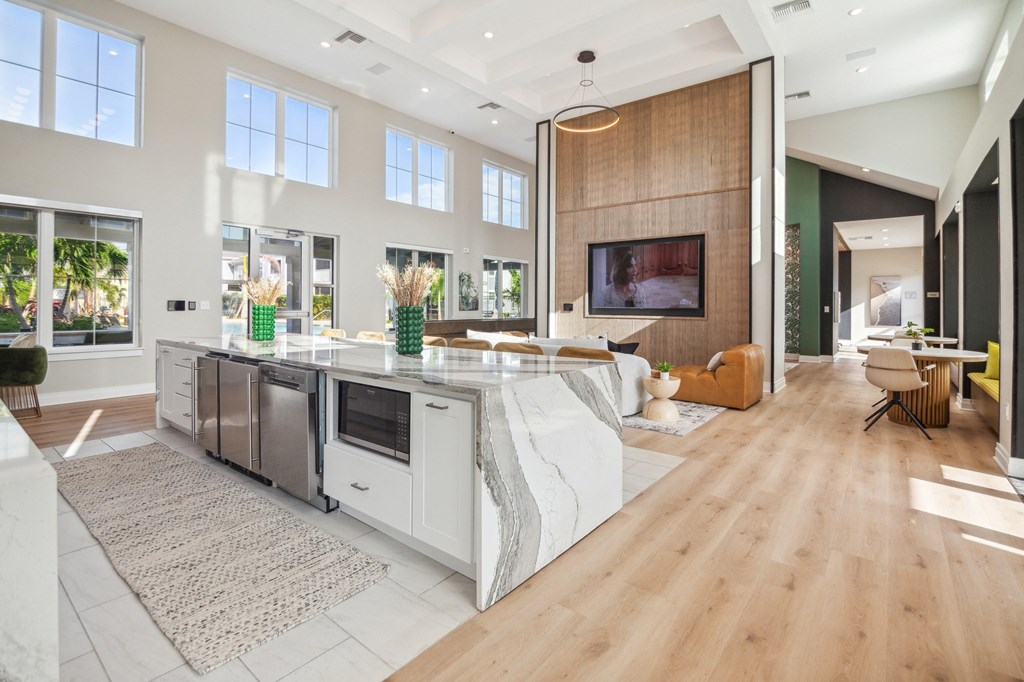 a large living room with a kitchen and a television  at Palm Grove, Ellenton, FL, 34222