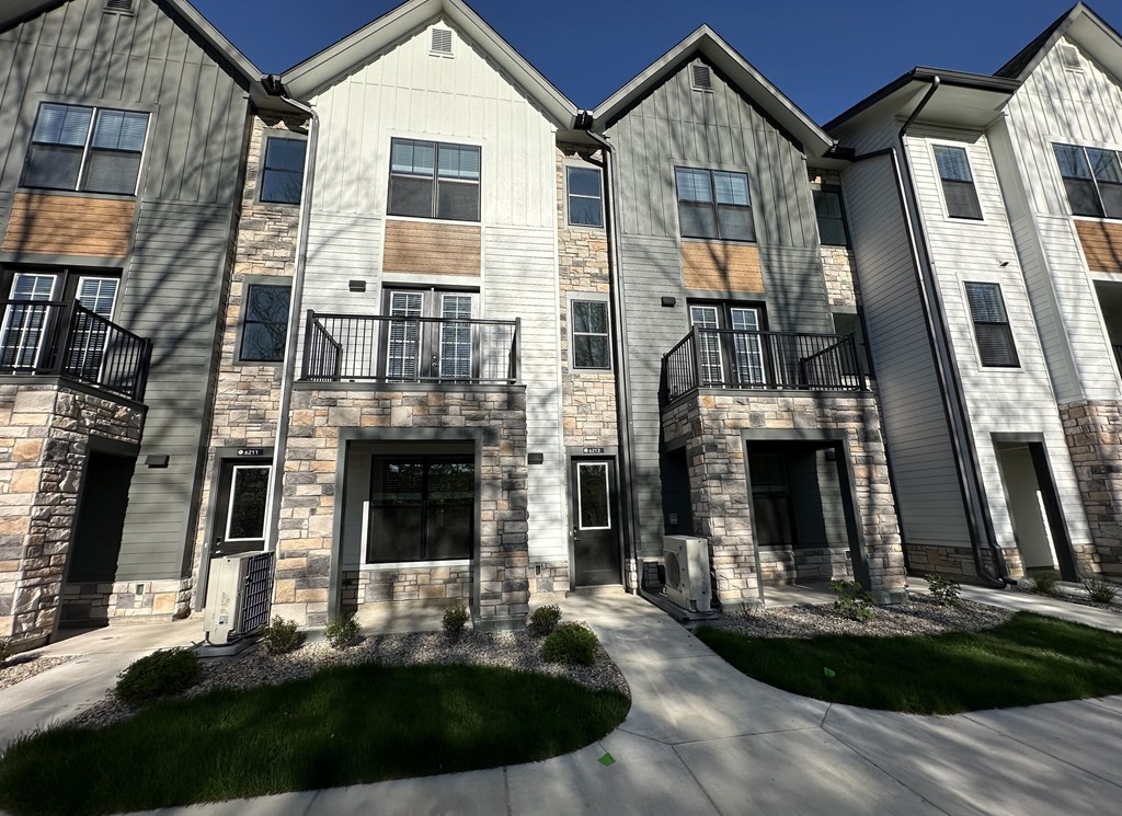 an exterior view of a building with stone and wood accents at The BLVD at Wilson Crossings, Wyoming