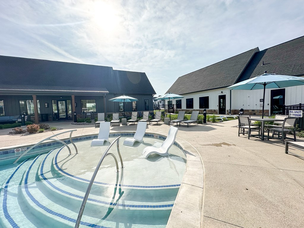 a swimming pool with chairs and umbrellas outside of a building at The BLVD at Wilson Crossings, Wyoming