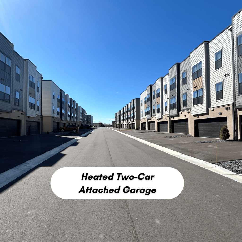 an empty street with rows of apartment buildings on both sides t Meridian at CityPlace, Woodbury, MN 55125