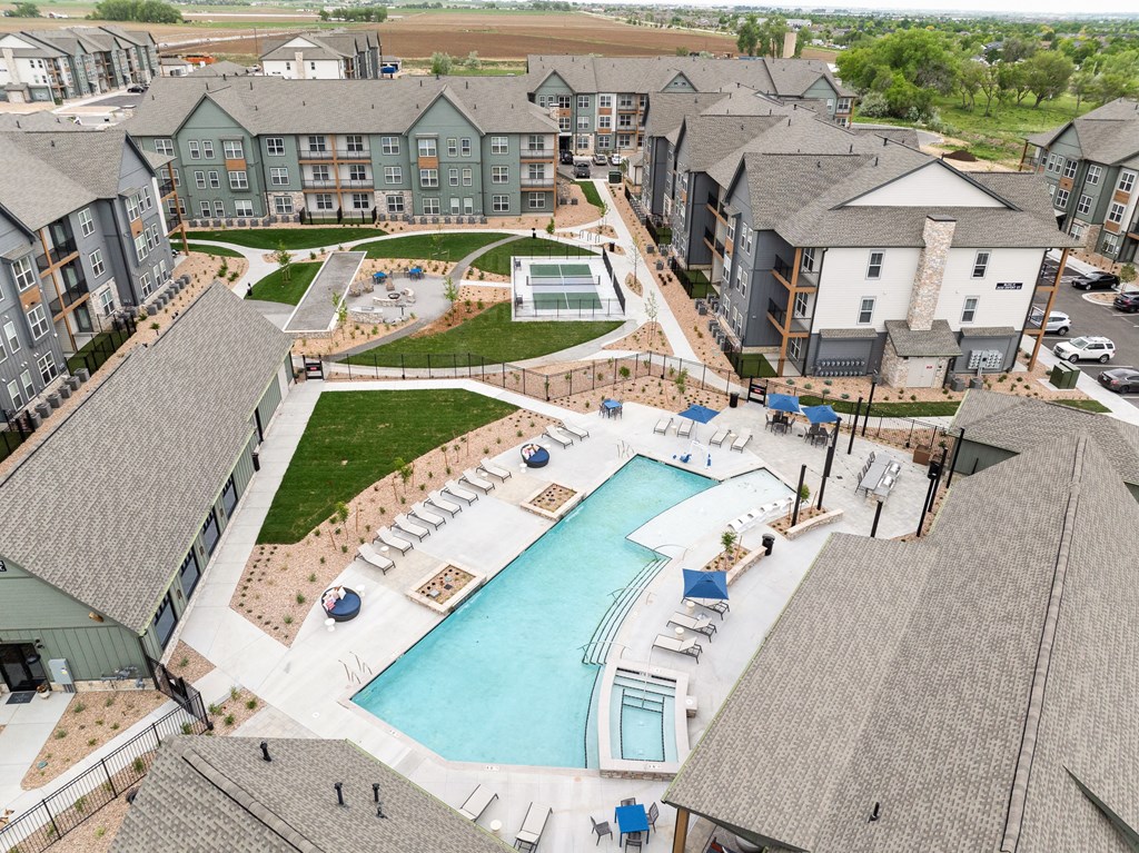 an aerial view of an apartment complex with a swimming pool