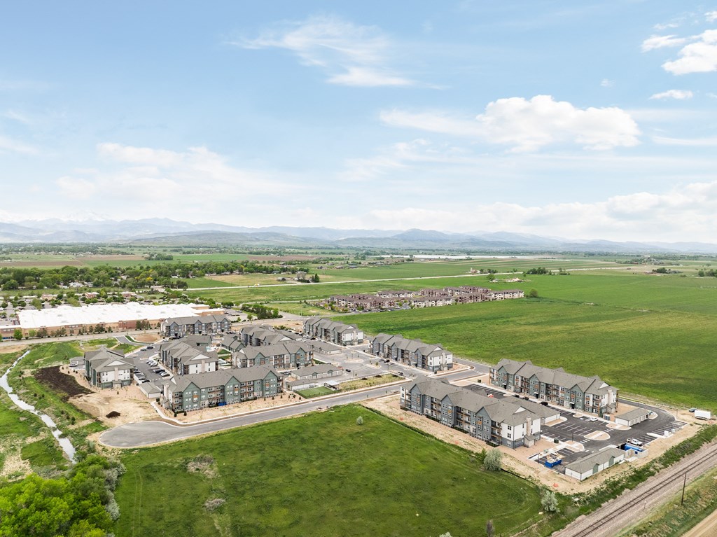 an aerial view of a large group of houses in a field