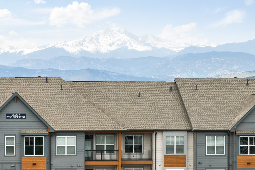 the roof of a building with mountains in the background