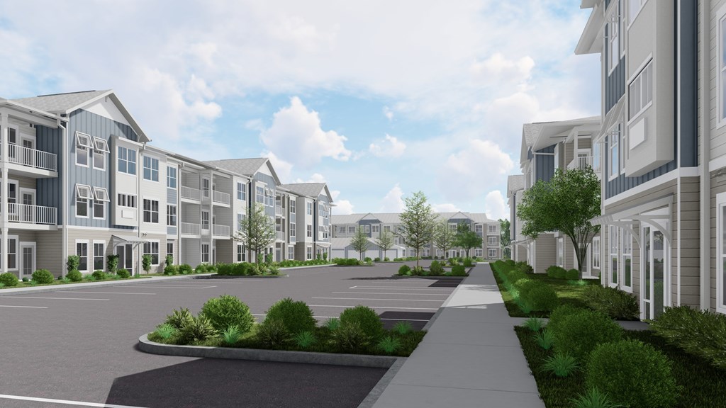 A row of modern townhouses with a sidewalk and landscaping in front.
