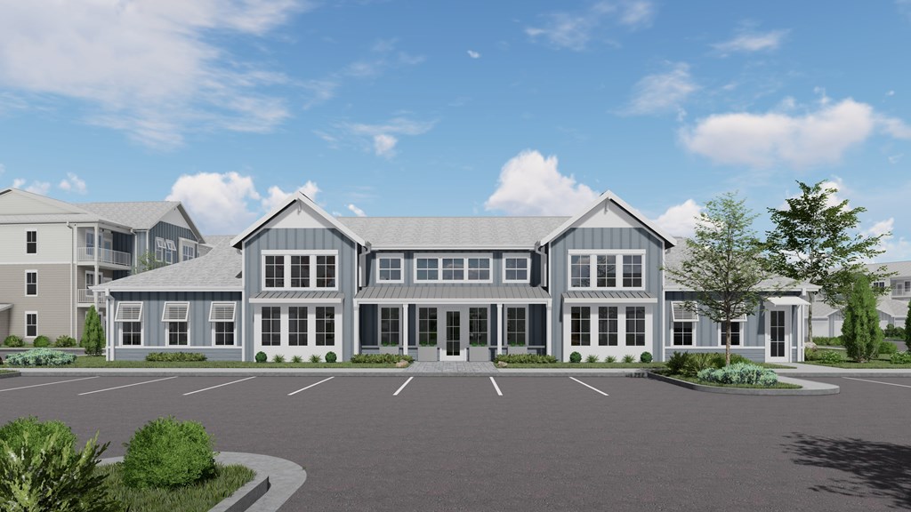 A large, modern building with a parking lot in front.