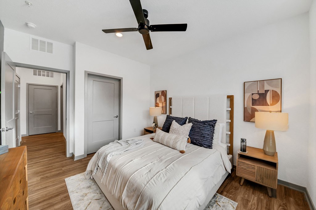 a bedroom with a bed and a ceiling fan at The BLVD at Wilson Crossings, Wyoming, MI