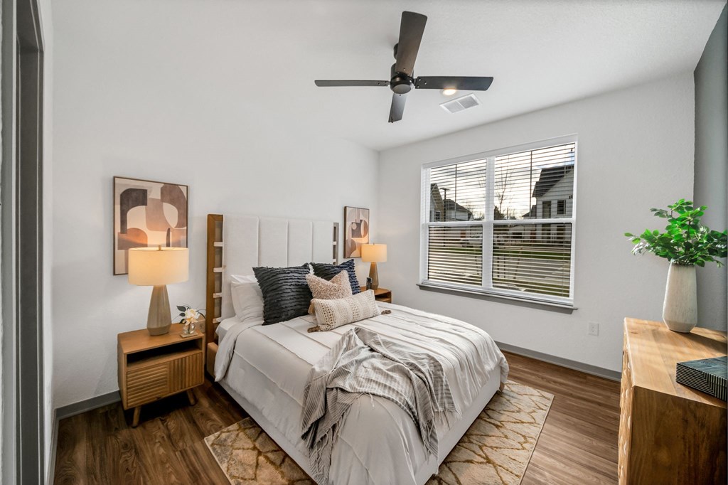 a bedroom with a large bed and a ceiling fan at The BLVD at Wilson Crossings, Michigan