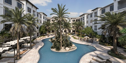 A pool surrounded by palm trees and white buildings.
