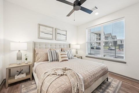 bedroom a bedroom with a bed and a ceiling fan at The Garrison Luxury Apartment Homes, Colorado