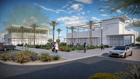 A modern building with a white facade and palm trees in front.at The Residences at The Gilmore in Gilbert, AZ