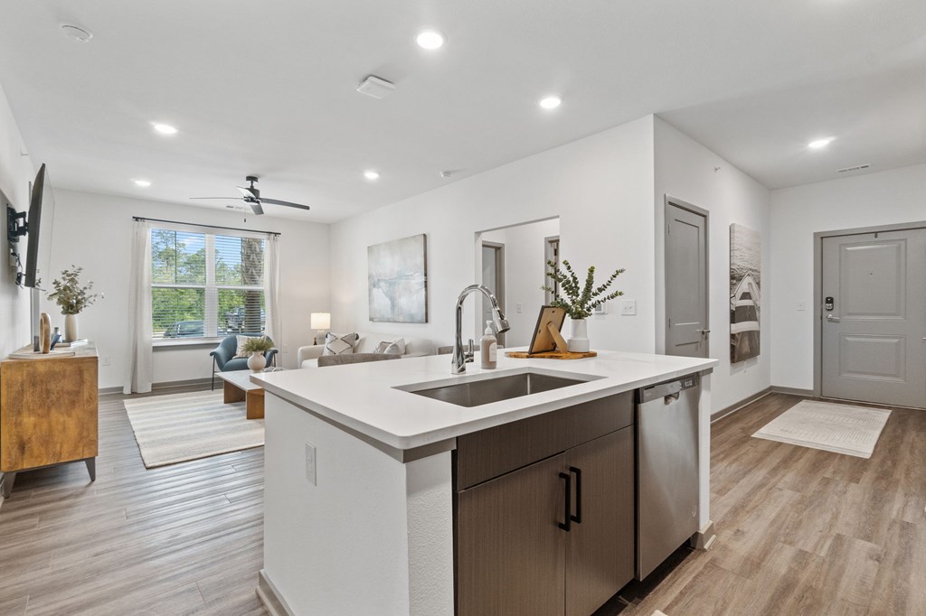 A modern kitchen with a large island and stainless steel appliances.