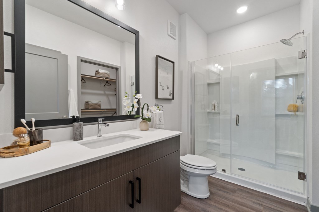 A modern bathroom with a white sink and a toilet.