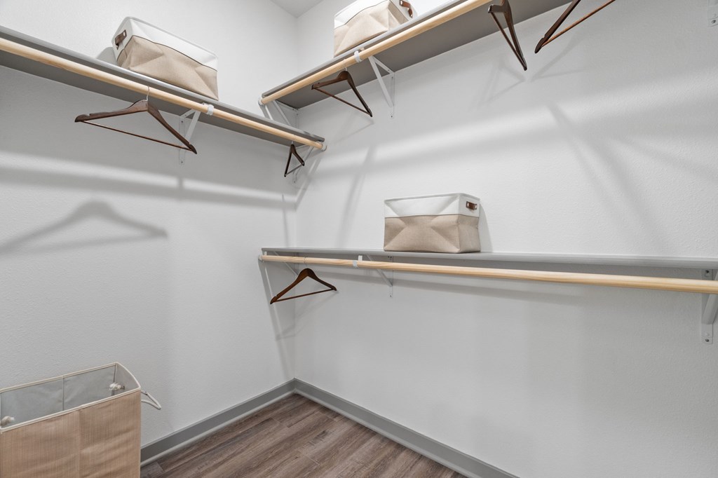 A room with three shelves and a hanger.