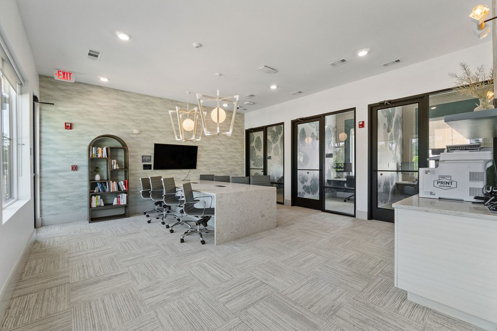 A well-lit office space with a reception desk and a bookshelf.