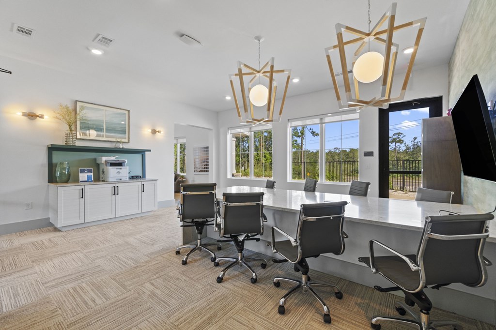 A conference room with a long table and chairs.