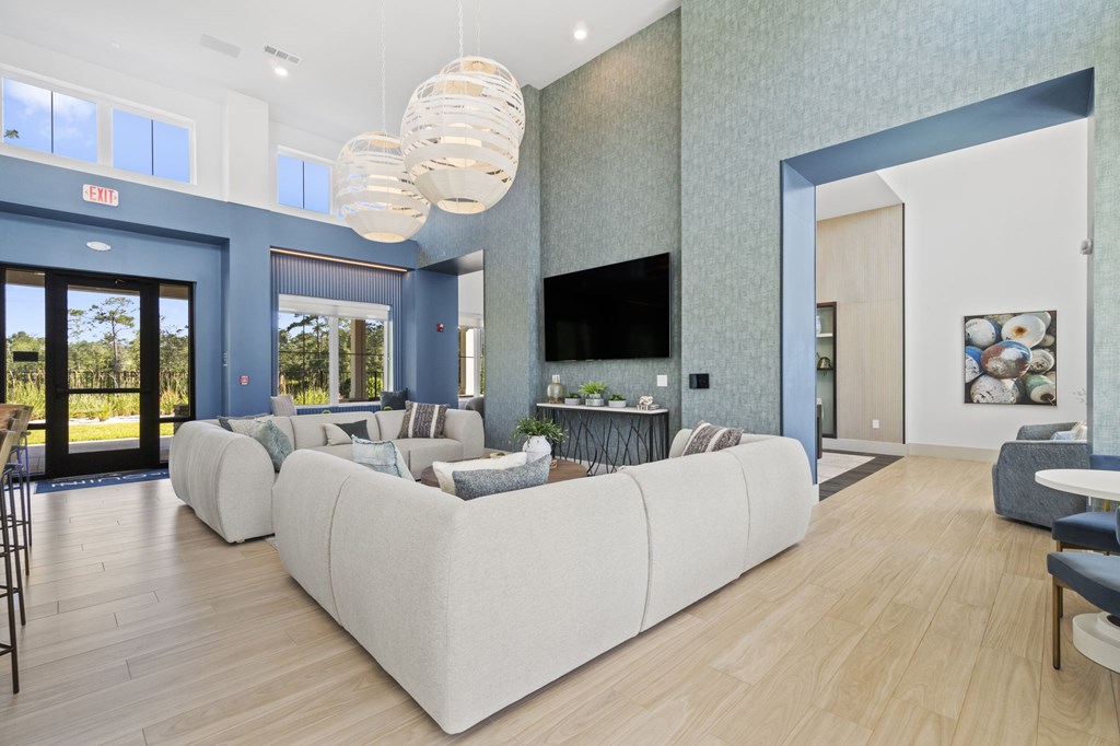 A living room with a white couch and a television.