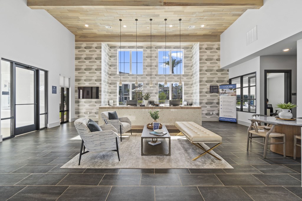 A modern living room with a stone wall and a large window.