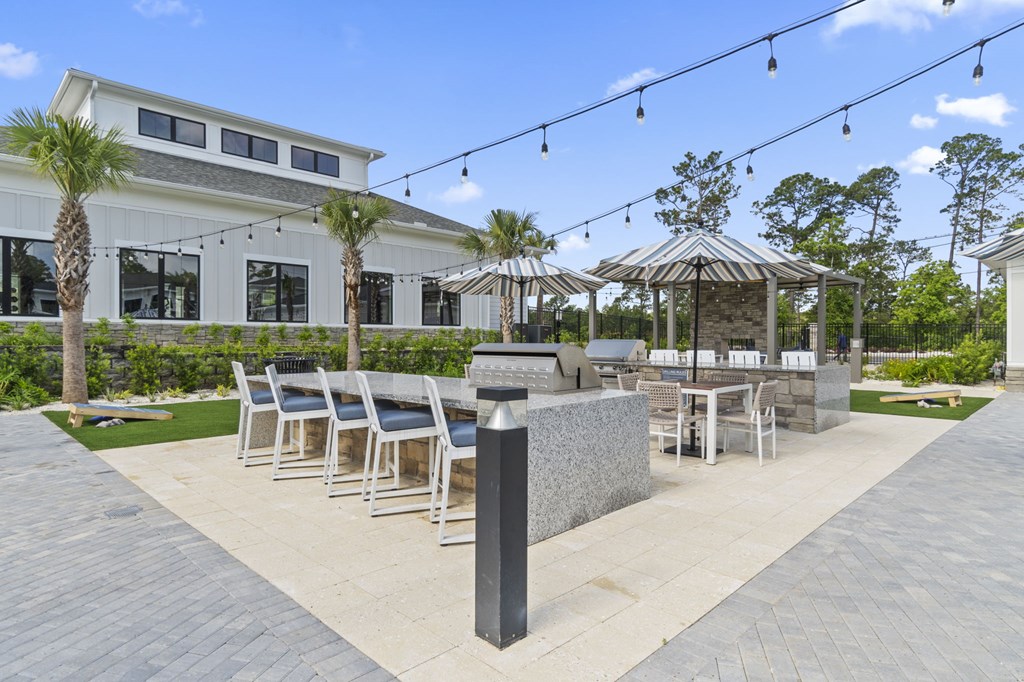 A patio area with a table set for dining and a gazebo.