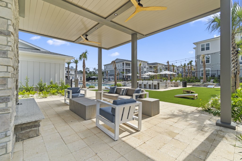 A patio with a white table and chairs under a canopy.