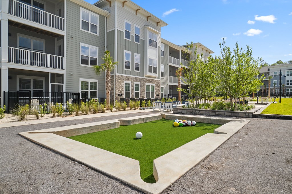 A grassy area in front of apartment buildings.