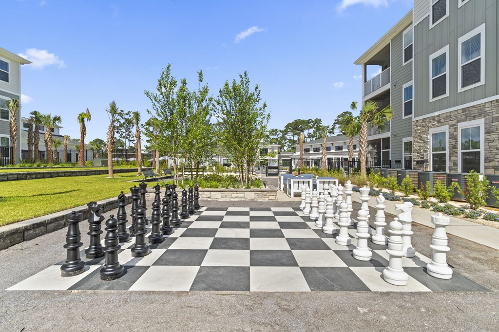 A giant chess board in the middle of a courtyard.