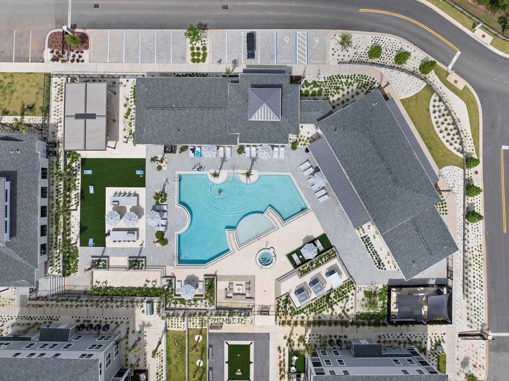 A bird's eye view of a resort with a swimming pool.