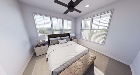 A bedroom with a large bed and a ceiling fan.