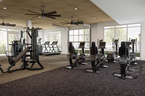 A gym with a variety of equipment including treadmills, weights, and exercise machines.