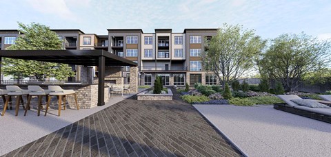A modern building with a patio and a bar at Stack at Wheat Ridge Apartments, Colorado