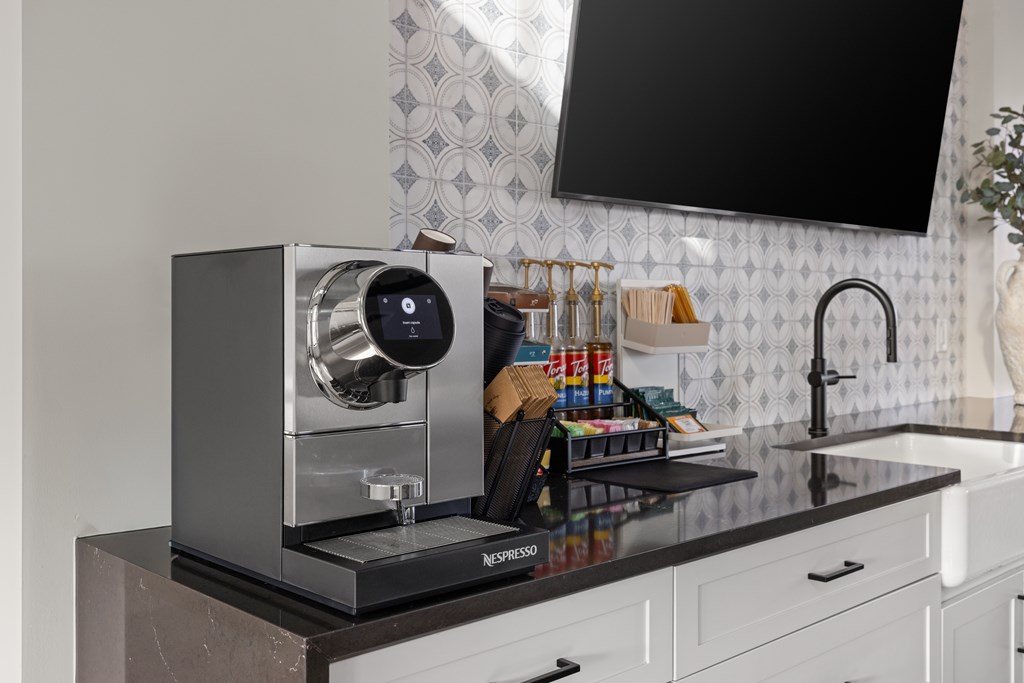 A Nespresso coffee machine sits on a countertop in a kitchen.