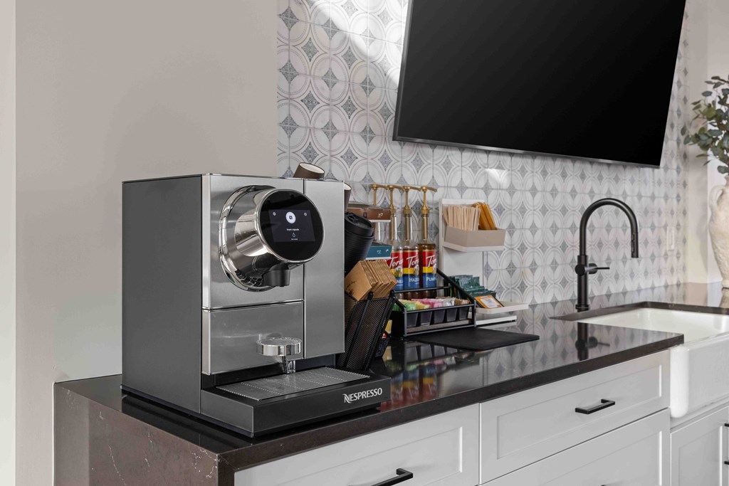 A Nespresso coffee machine sits on a kitchen counter.
