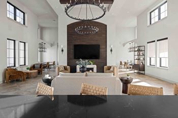 A large, modern living room with a fireplace and a dining table set up.