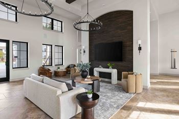 A modern living room with a fireplace and a large couch.