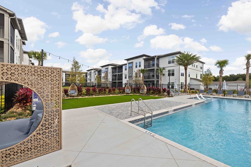 A pool area with a large building in the background.