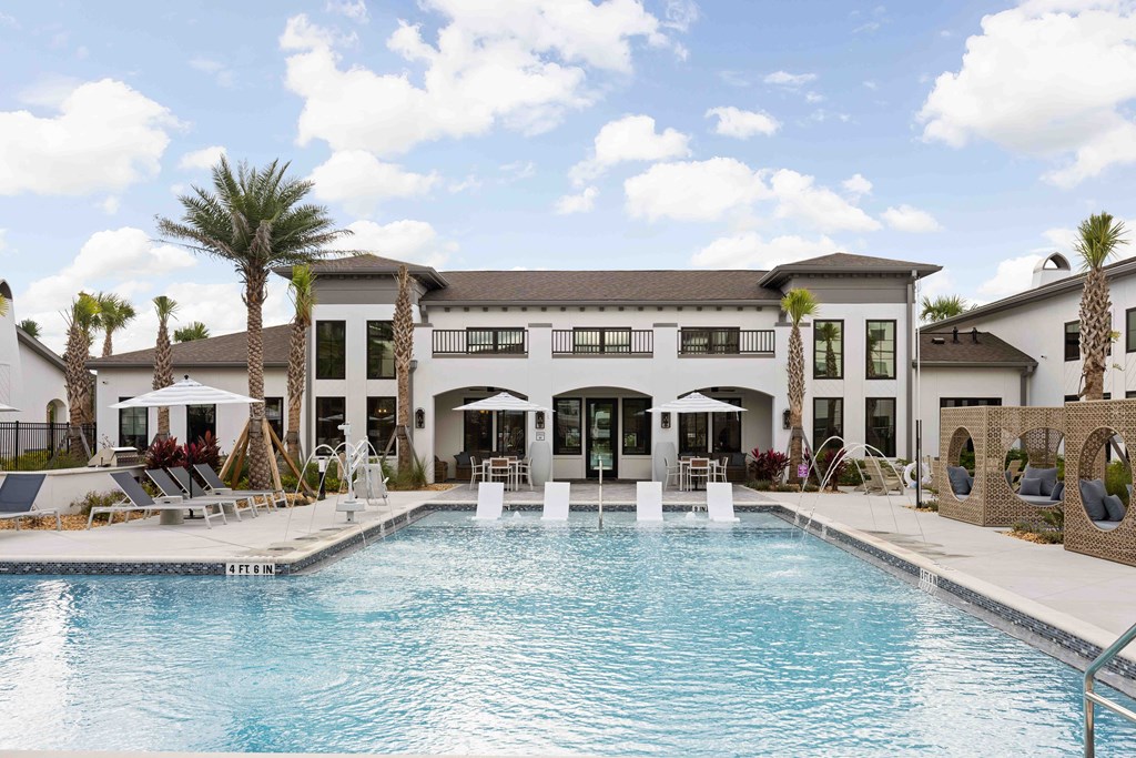 A large house with a pool in front.