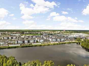 A large body of water surrounded by trees and buildings.