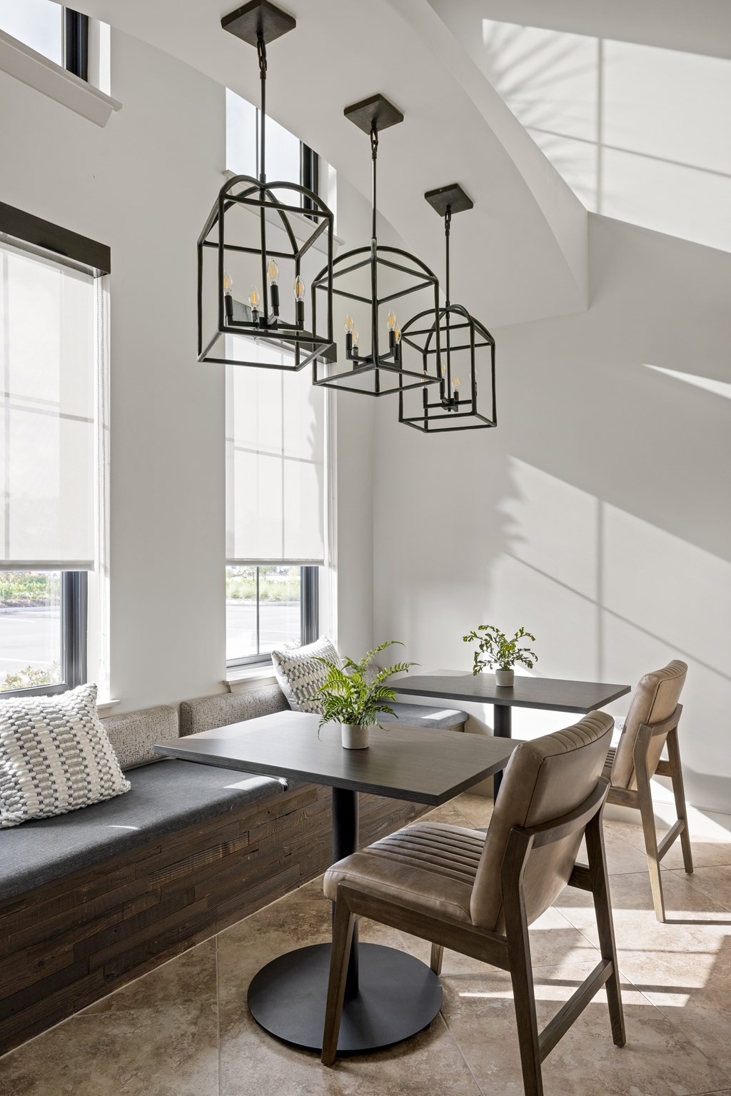 A modern dining room with a glass table and chairs.