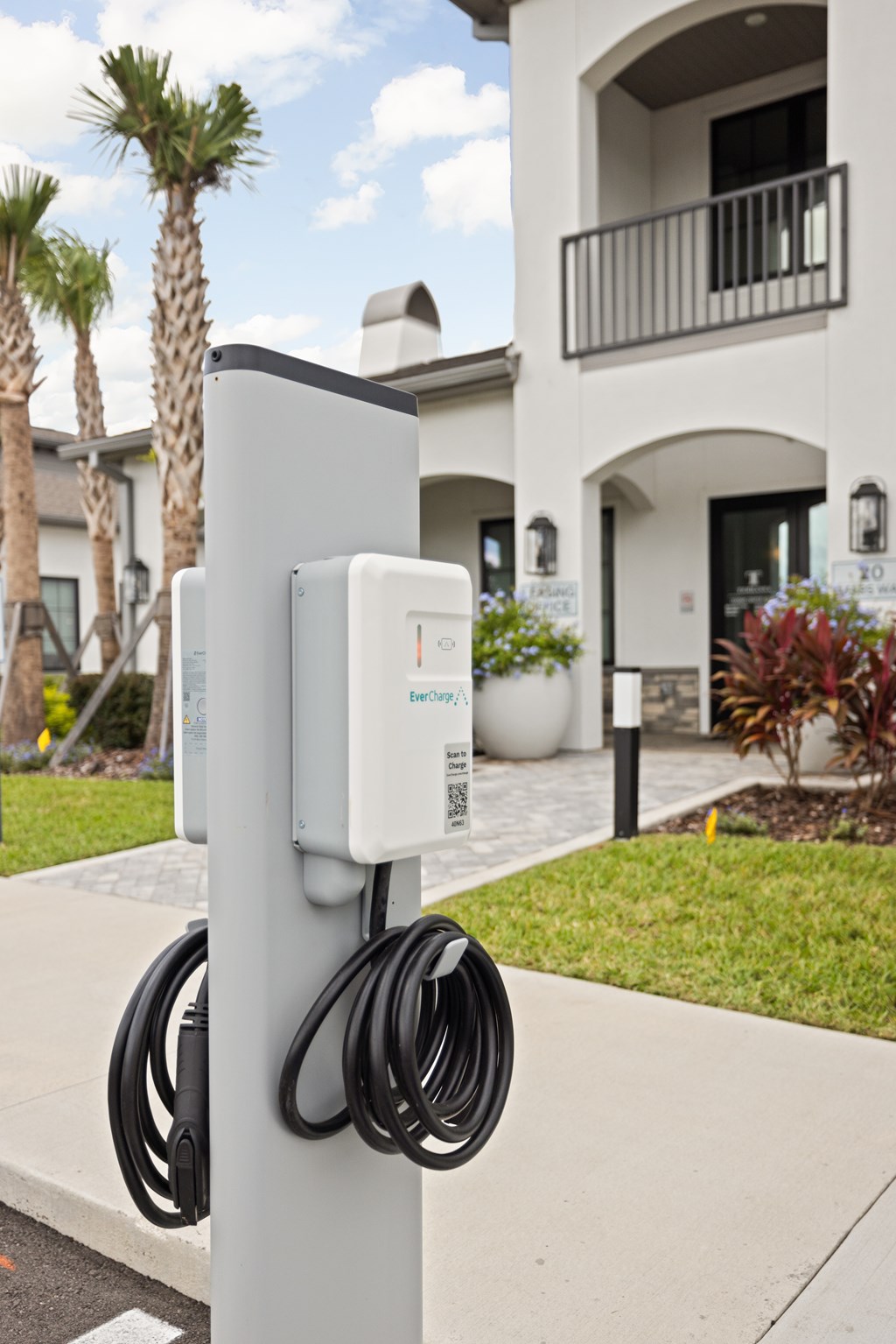 A charging station for electric vehicles is installed on a pole.