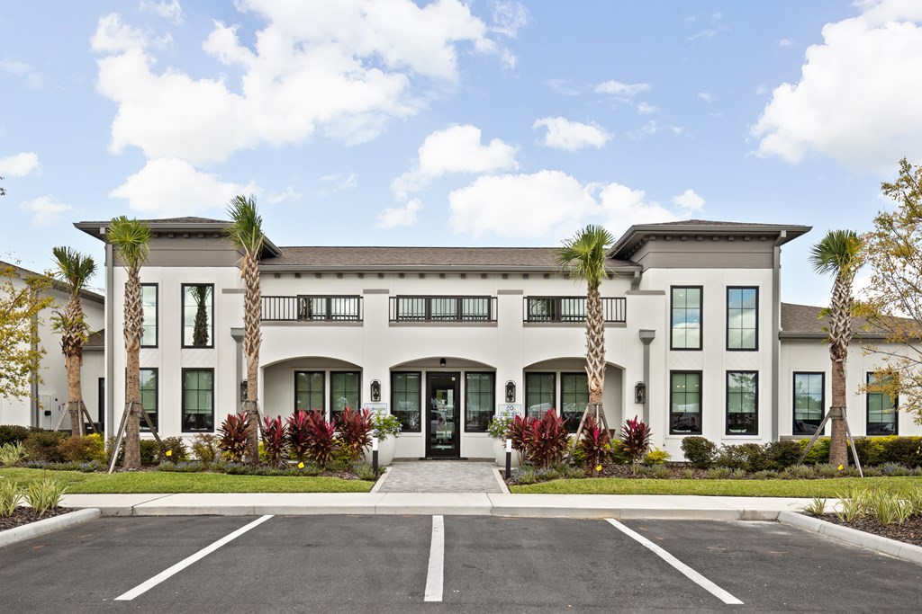 A large white building with a black roof and a black front door.