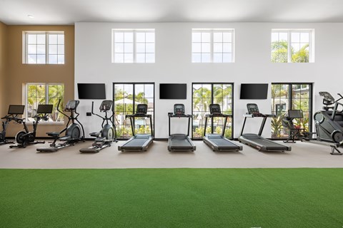 A gym with treadmills, exercise bikes, and other equipment.