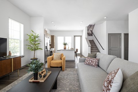 A living room with a grey couch and a coffee table.