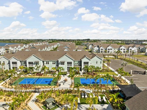 A large residential complex with a swimming pool and tennis courts.