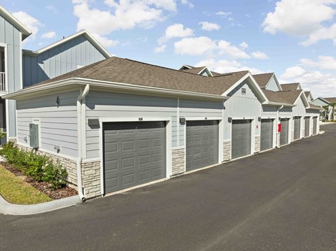 A row of houses with garages on the side.