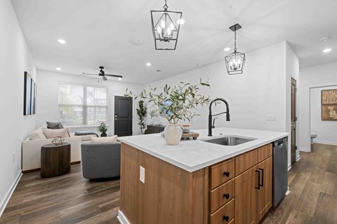 A modern kitchen with wooden cabinets and a white countertop.