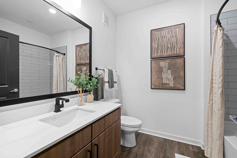 A bathroom with a white sink and a toilet.