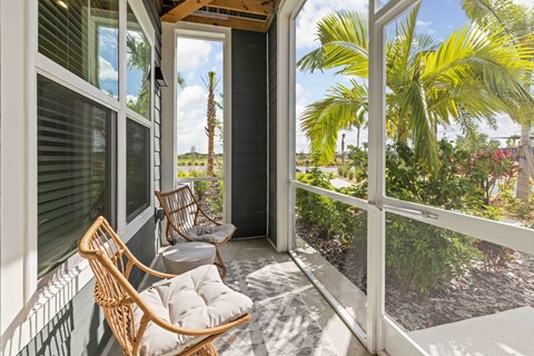 A balcony with a chair and a table.