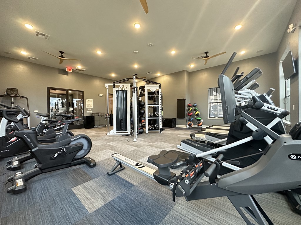 spacious gym with cardio equipment at the oxford condos tx at Watermark at Steele Crossing, Fayetteville, Arkansas